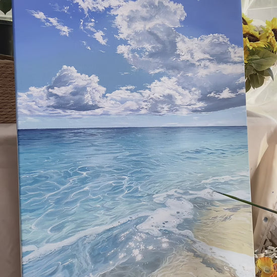 Real studio video showing the finished blue seascape, cloud and water brushwork, and the completed painting on an easel