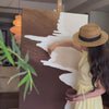 An artist creates a brown and white painting, with the original sound of the studio.