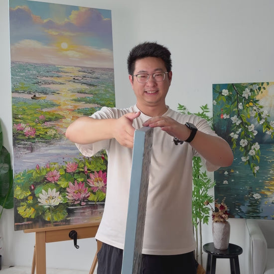 Studio video turning the painting from a narrow side view to a full view of a woman in a flowing dress beside the sea