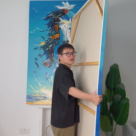 Real studio video showing the back and turning the painting to reveal a blue fish school surrounding two divers