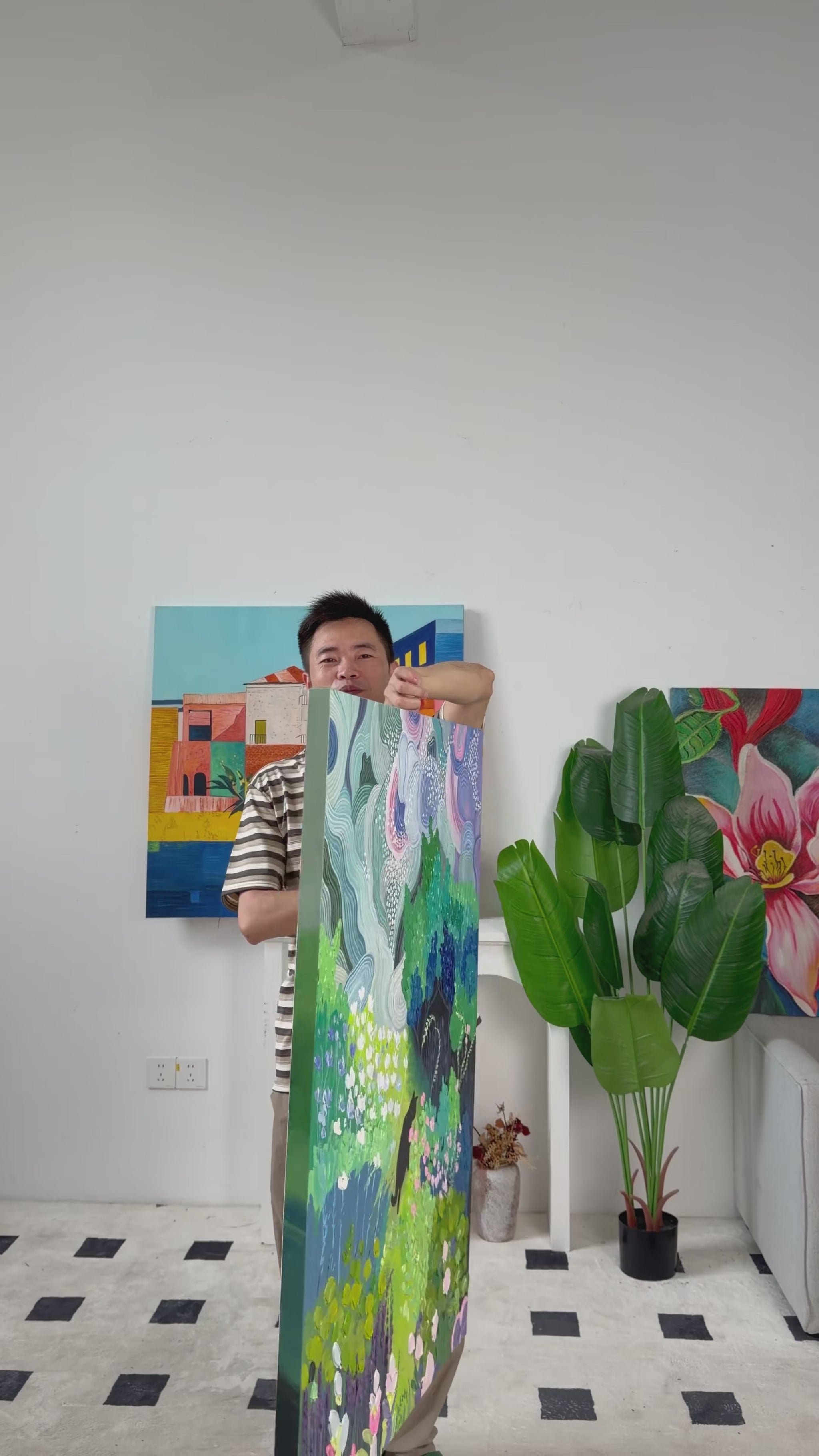 Real studio video of the supplier turning the painting from an angled view to reveal the black cat, colourful garden and curved pastel bands